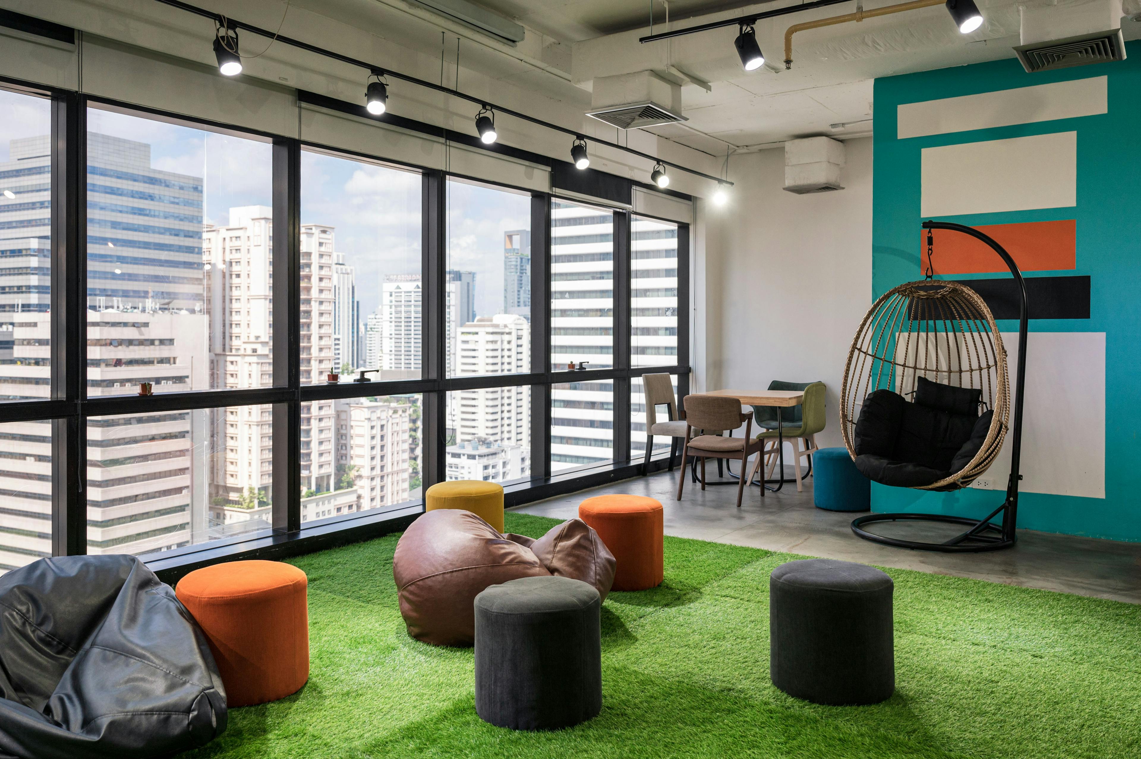 creative-room-coworking-space-with-cushions-chairs-artificial-grass-modern-office